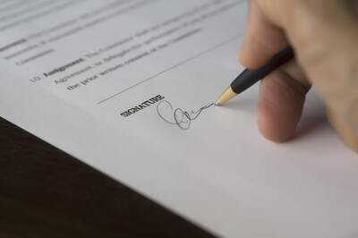 person signing a contract